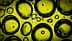 Close-up image of oil droplets on a yellow background with a focus circle overlay. - Olive Oil Times