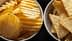 Two bowls containing potato chips and tortilla chips arranged side by side. - Olive Oil Times