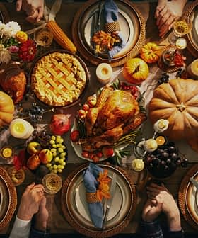 A beautifully arranged Thanksgiving dinner table with a turkey, pie, and various seasonal decorations. - Olive Oil Times