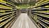 A supermarket aisle lined with shelves of olive oil bottles in various sizes and packaging. - Olive Oil Times