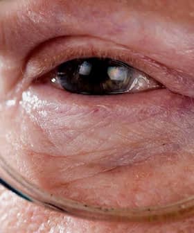 Close-up view of an elderly person's eye wearing glasses, showing fine details of the skin and eye. - Olive Oil Times