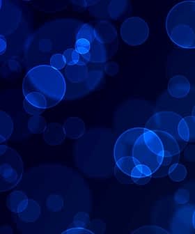 Abstract blue bokeh background with circular shapes and varying sizes. - Olive Oil Times