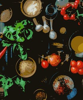 An overhead view of various cooking ingredients including vegetables, herbs, and spices on a wooden surface. - Olive Oil Times